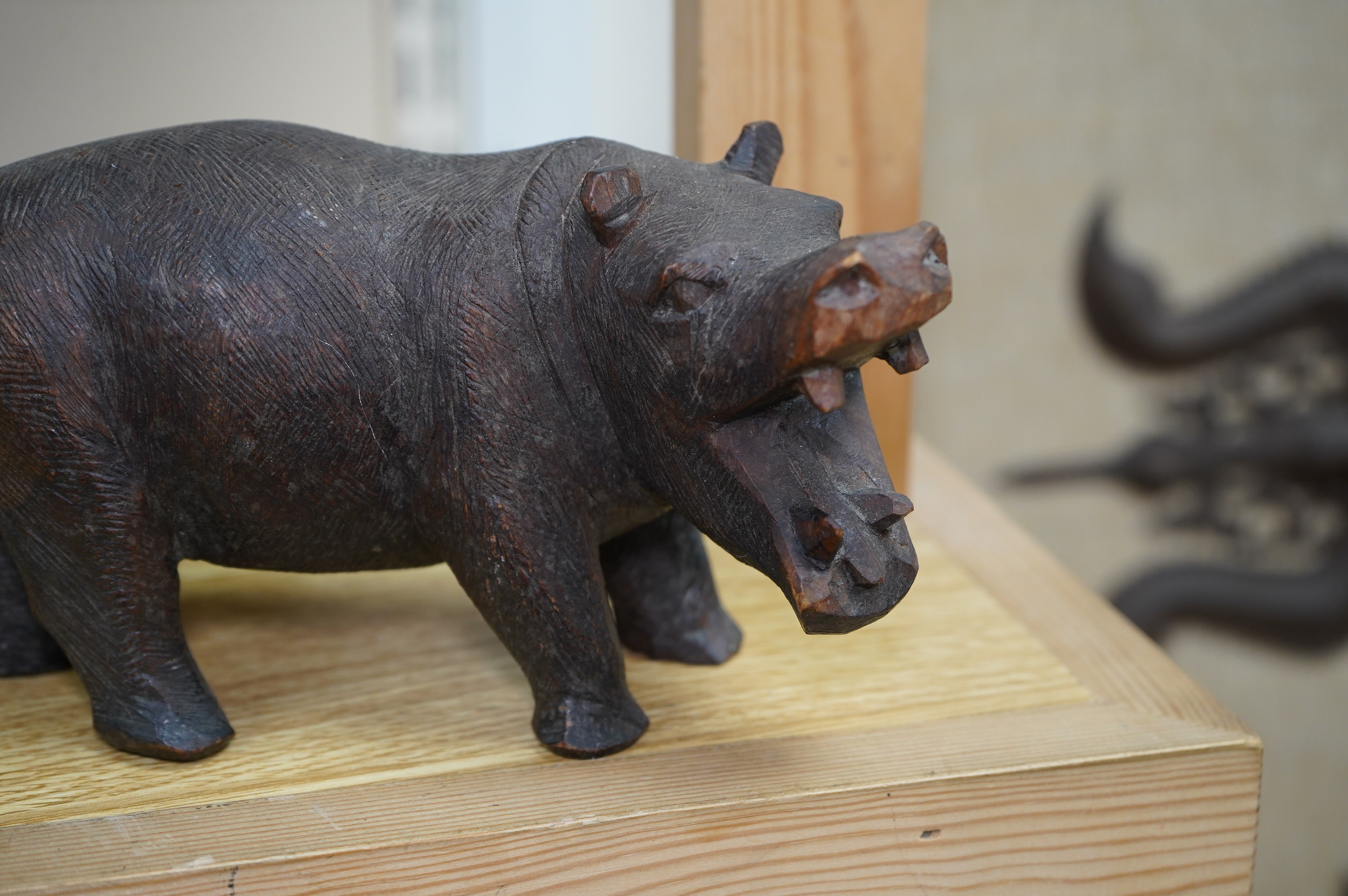 Five carved Black Forest bears, two in the form of ink blotters, together with an African figure of a hippopotamus, largest 17cm wide. Condition - poor to fair